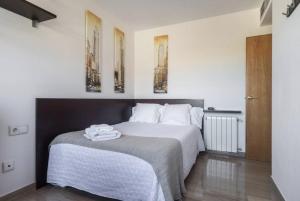 a bedroom with a bed with two mirrors on the wall at Art and Sciences view luxury apartment in Valencia