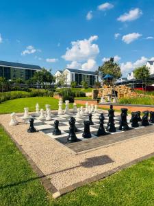 a giant chessboard in a park with buildings in the background at Lethabo Eco_Estate in Boksburg
