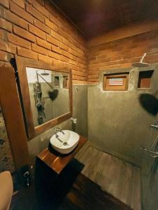a bathroom with a sink and a mirror at NatureWoodland in Ella