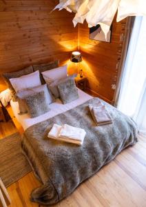 a bedroom with a large bed in a wooden room at Chambres et table d'hôtes au chalet Datcha in Briançon