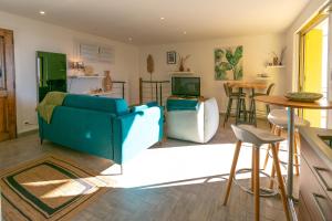 a living room with a blue couch and a table at Appartement Vue mer, 2ch, 60m². in Théoule-sur-Mer