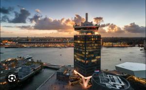 a tall building with a tower on top of it at Charming Rooms with free parking in Amsterdam