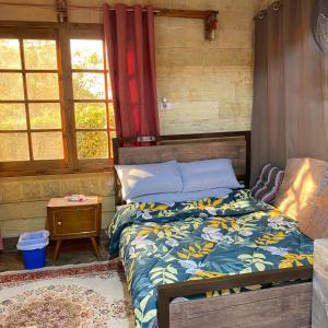 a bedroom with a bed in a room with windows at Sunny-suite in new Cairo in Cairo