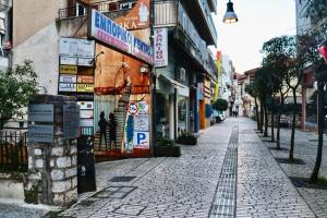 a street with signs on the side of a building at Mystique Loft Ioannina in Ioannina