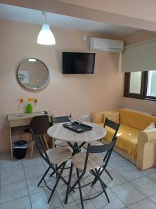 a living room with a table and chairs and a couch at Nini's House 1 Nydri - 100m from beach NYDRI TOWN CENTER in Nydri