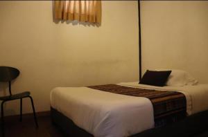 Postel nebo postele na pokoji v ubytování Hotel FLORA Suesca