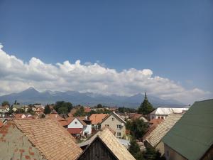 a town with roofs and mountains in the background at Penzion Važec in Vysoke Tatry - Strbske Pleso