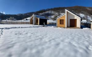 kilka budynków w śniegu w obiekcie Mountain Mirage w mieście Mojkovac