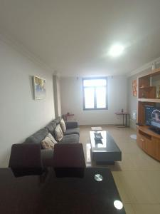 a living room with a couch and a coffee table at Appartement vista mar in Puerto del Rosario