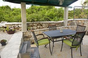 a table and chairs sitting on a patio at Country House Vinko in Račišće