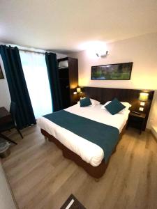 a bedroom with a large bed and a large window at Hôtel Mazagran in Paris