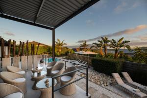 a patio with a bunch of chairs and a pool at THEBLOEM Guest Suites by Knysna Paradise Collection in Knysna