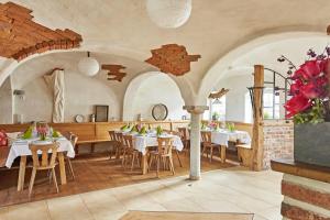 a restaurant with tables and chairs in a room at Scheilhof in Hirschbach