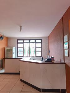 a kitchen with a large island in the middle at Hotel Beira Rio Preguiças in Barreirinhas