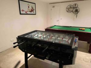 a pool table sitting in a room next to a table at Norwich city centre, Norfolk, free car parking. in Norwich