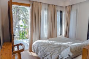 a bedroom with a bed and a large window at Villa Ferrer in Mahatao