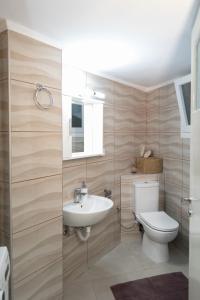 a bathroom with a toilet and a sink at Santa Marina 2 in Ioannina