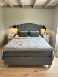 a bedroom with a large bed with two night stands at Gezellig huisje met mooi uitzicht in Holmestrand