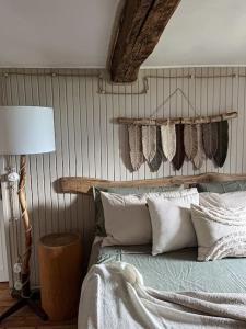 a bedroom with a bed with pillows and a lamp at Cà d’la Giannina • local experience Valle Antrona in Pallanzeno