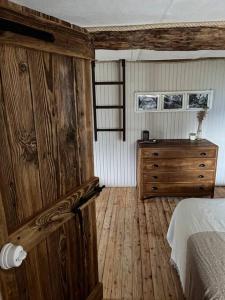 ein Schlafzimmer mit einem Bett und einer Holzkommode in der Unterkunft Cà d’la Giannina • local experience Valle Antrona in Pallanzeno