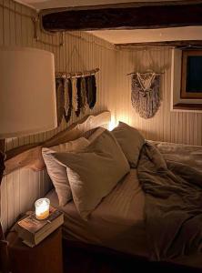 a bedroom with a bed with pillows and a lamp at Cà d’la Giannina • local experience Valle Antrona in Pallanzeno