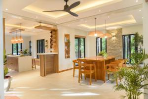a dining room and kitchen with a ceiling fan at Villa Ferrer in Mahatao