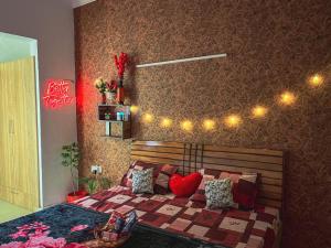 a bedroom with a bed with lights on the wall at Love Lounge in Greater Noida