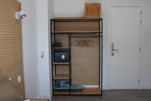 una habitación con un estante de libros con un ordenador. en Bambú Suites Vegueta, en Las Palmas de Gran Canaria