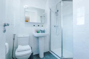 a white bathroom with a toilet and a shower at Stays Lilies House in Chester