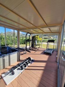 Private villa relax 2 &spa في Borgetto: غرفة مع صالة رياضية مع أجهزة ركض ومحاكي
