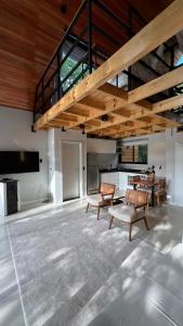 a large living room with a table and chairs at Cabanas Jardim de Tereza in São Joaquim