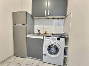 een keuken met een wasmachine en een koelkast bij Cocon de Champs *Disney*Paris*Wifi* in Champs-Sur-Marne