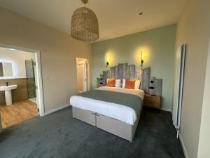 a bedroom with a large bed and a bathroom at Balmoral Hotel in Blackpool