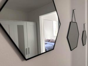 a mirror hanging on a wall next to a bedroom at NEW Studio, 2mn walk to Monaco in Beausoleil