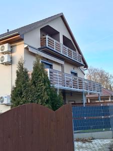 a house with a fence in front of it at Lokomotív Apartman in Balatonmáriafürdő