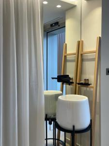 a salon with two white chairs and a mirror at Balance Accommodation in Stavros