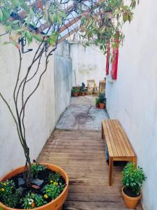 a patio with a table and a tree in a pot at Charmante maison a deux pas du centre in Nantes
