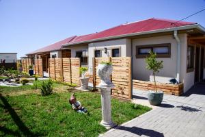 a house with a bird statue in the yard at Menucha Country Lodge in Mthatha