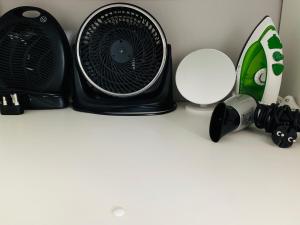 a black fan sitting on top of a table at Lower Point Surf Studio in Jeffreys Bay