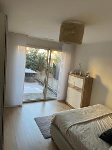 1 dormitorio con 1 cama y puerta corredera de cristal en Hennu B&B, en Zúrich