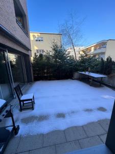 a patio with a table and a bench in a yard at Hennu B&B in Zurich