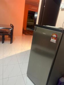a refrigerator with a sticker on the side of it at Nuha's Homestay Teluk Intan in Teluk Intan