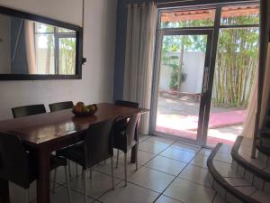 a dining room with a table and chairs and a window at Casa en Juan Angel Ver in Chachalacas