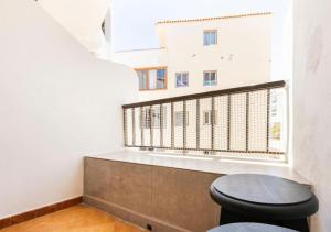 a bathroom with a toilet and a window at Cosy Apartment in Los Cristianos 5min to the ocean in Los Cristianos