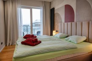 a bedroom with a large bed with a large window at Raspberry apartment and SPA in Dziwnów +56 photos