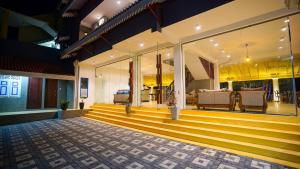 a lobby of a building with yellow steps at Beyond The Sea By Ceylonese in Ambalangoda