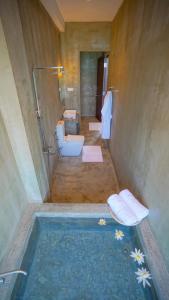a bathroom with a shower and a tub with a toilet at Beyond The Sea By Ceylonese in Ambalangoda