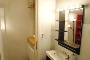 a bathroom with a sink and a mirror at Appartamento Arco della Pace in Milan