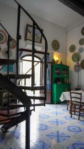 a room with a staircase and a room with a table at Casa Margherita in San Vito lo Capo +23 photos