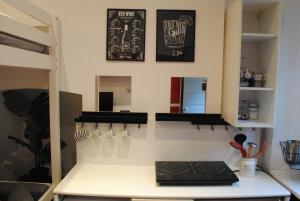 a kitchen with a counter top and a shelf at Appartamento Arco della Pace in Milan